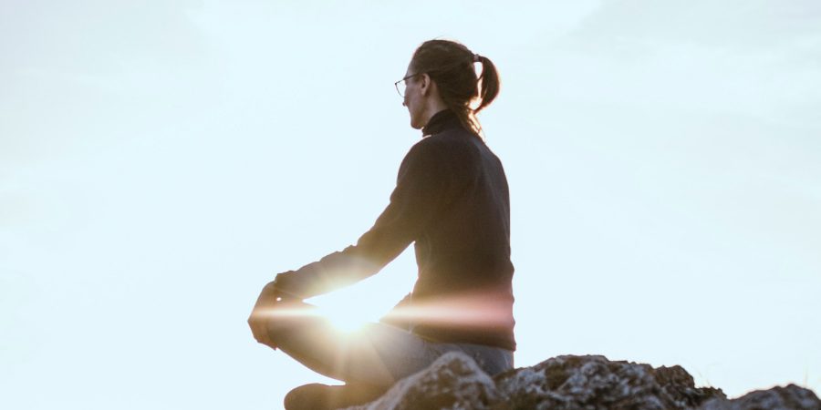 man doing meditation in the mountaine