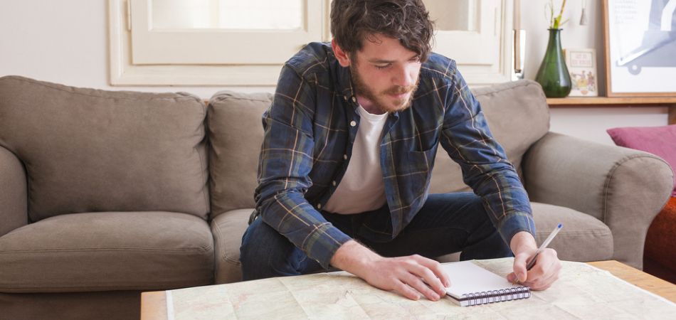 sober man writing in paper