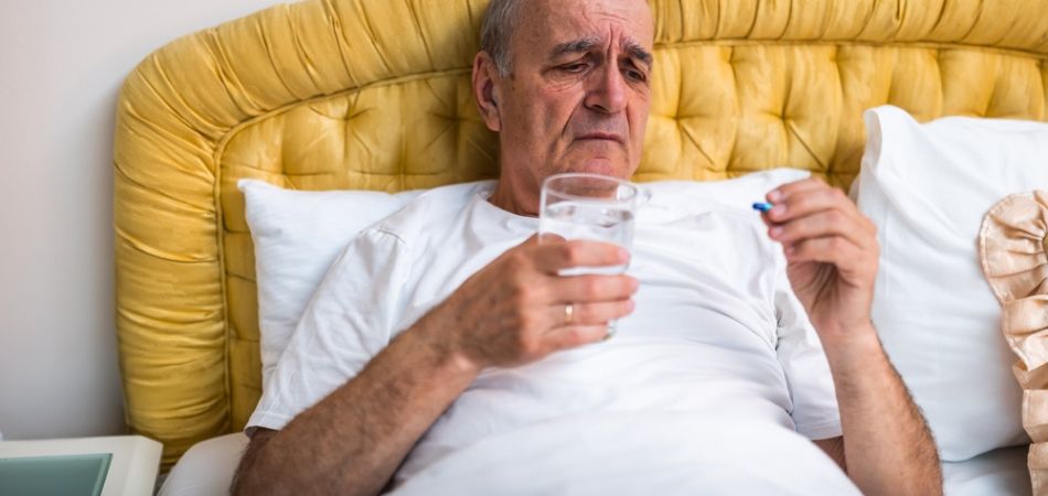 very old man struggeling with sleeping pills