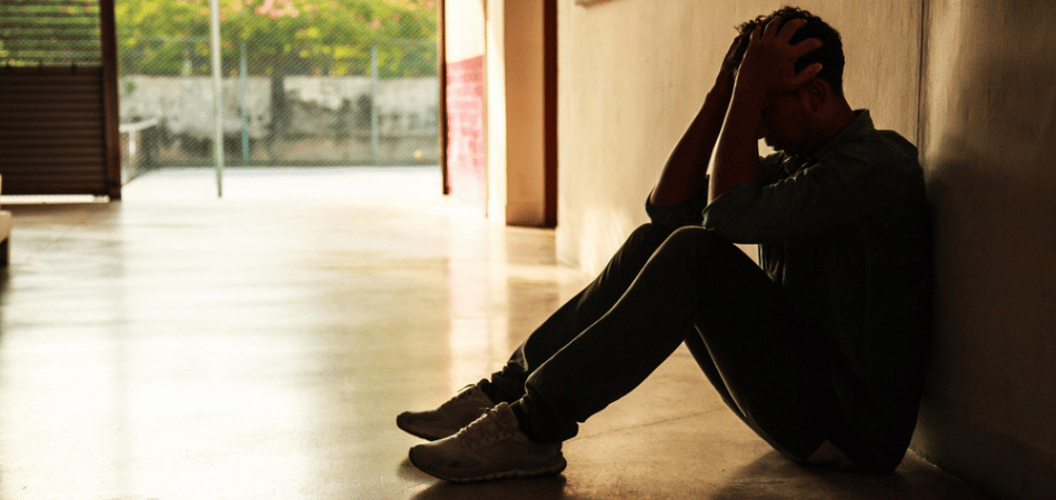 Man in depression sitting on floor