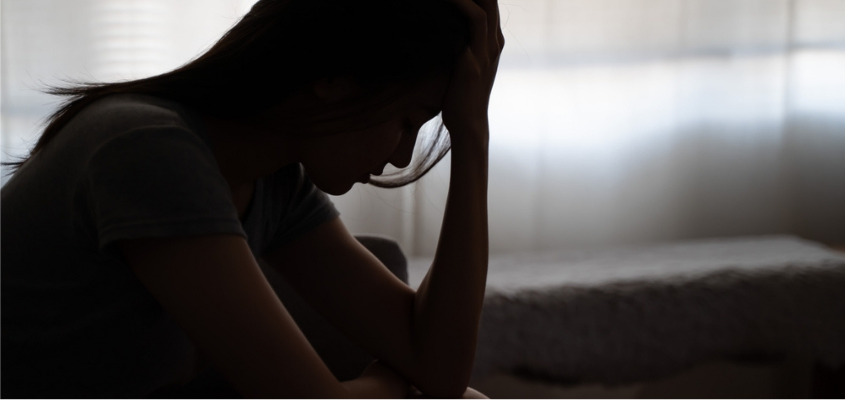 Woman on stress sitting on bed