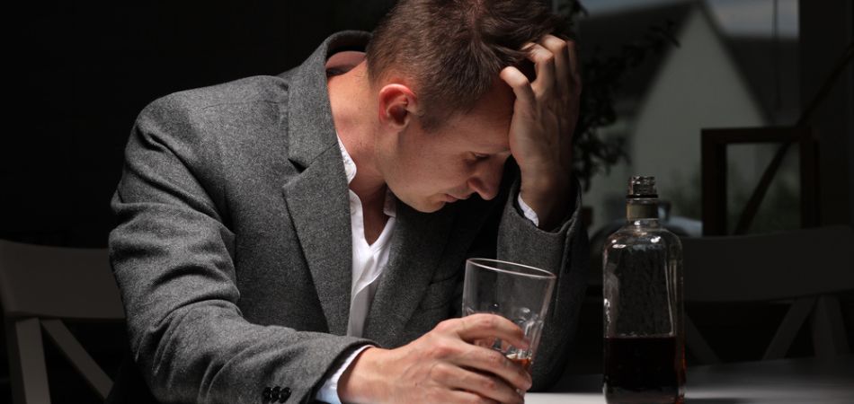 man-with-alcohol-and-glass-in-hand