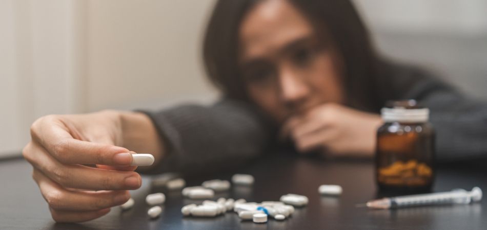 Woman taking anti drug pills