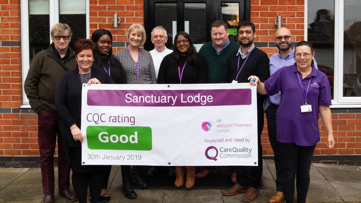 the sanctuary lodge team holding cqc result banner