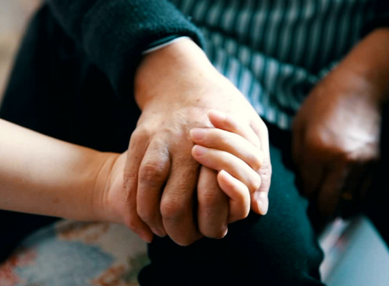 Caring hand hold from family member 2