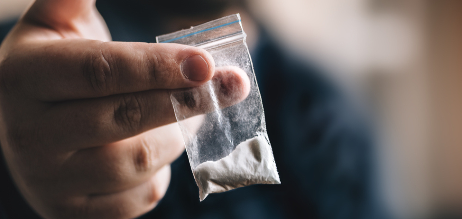 Man holding cocaine bag