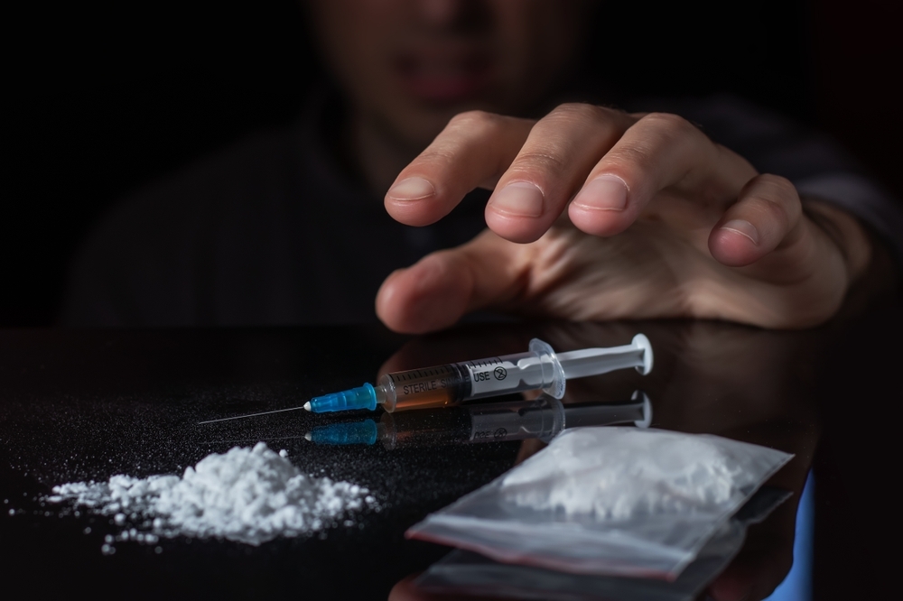 Heroin powder and injection on a table