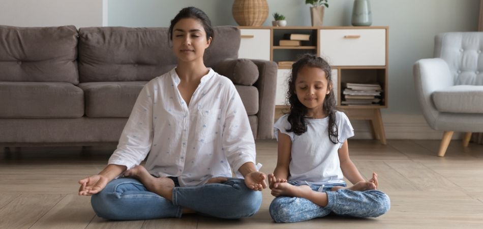Mother and daugher doing yoga