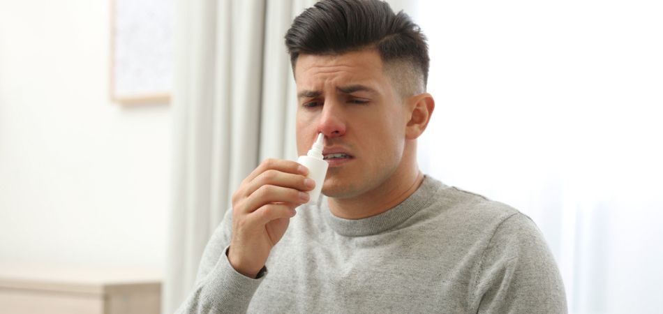 young man suffring runny nose