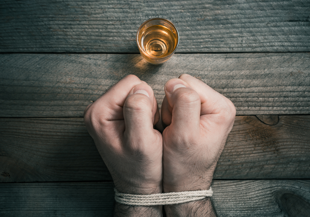 Man hand tie with alcohol glass