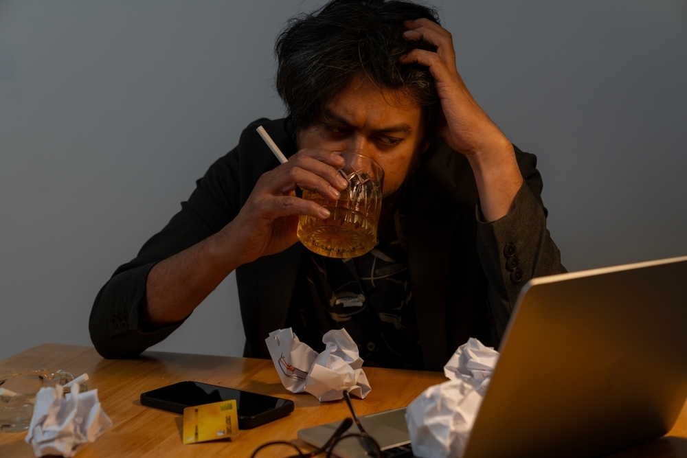 man-drinking-while-working