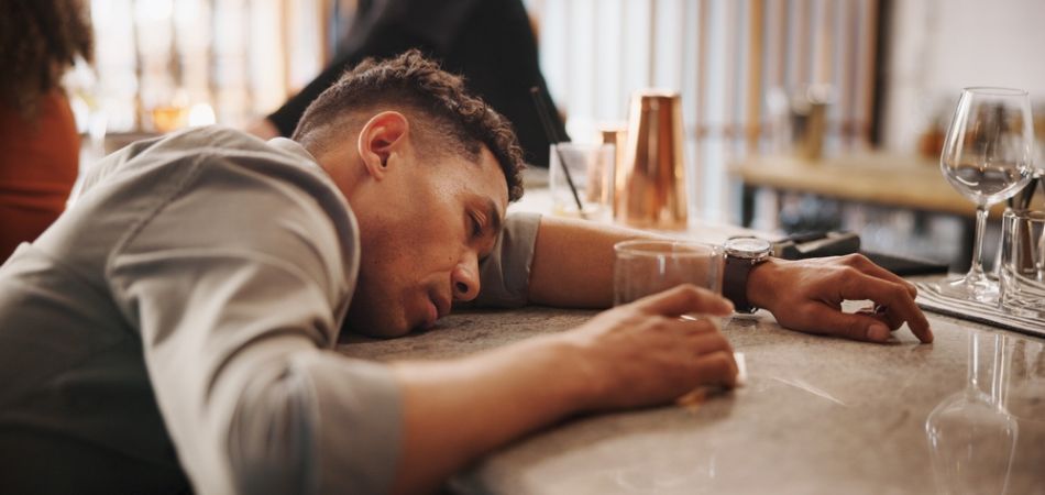 Drunk man lying on the table