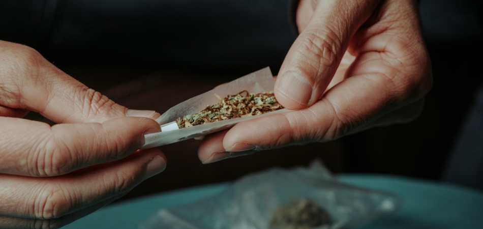 Cannabis addict rolling a joint