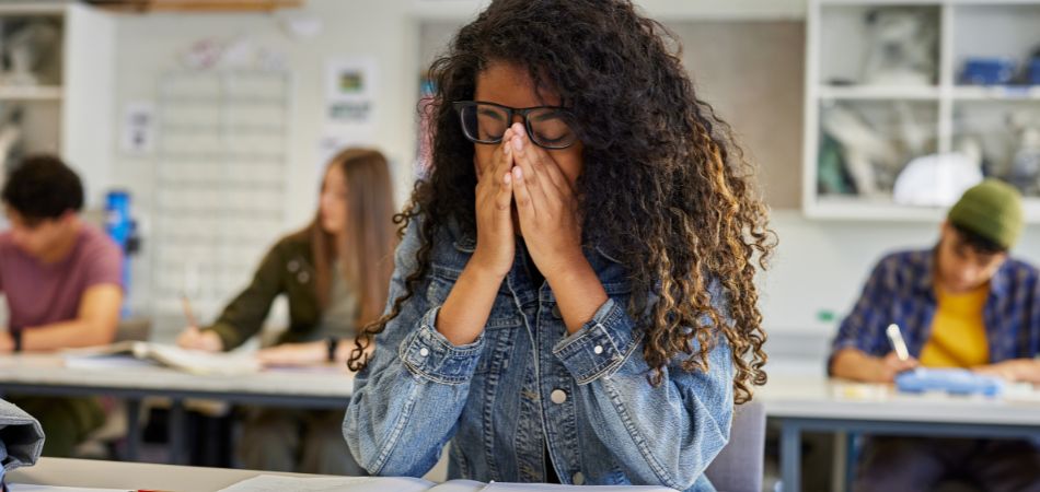 student suffring from streess in library