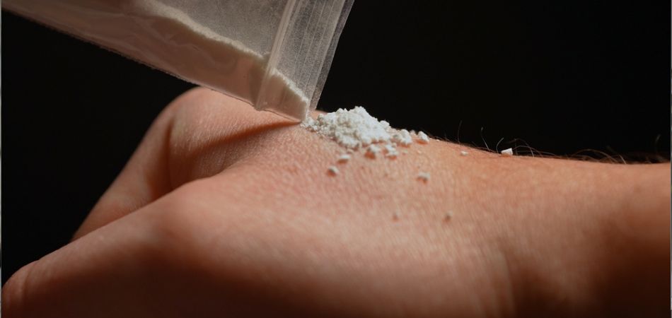 cocaine powder in hand